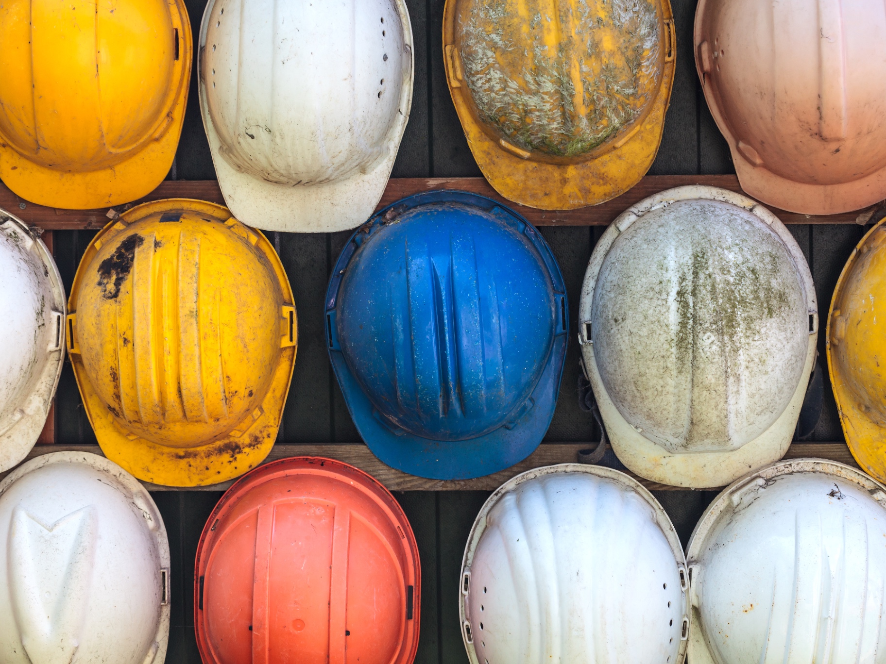 Rows of colored construction hard hats